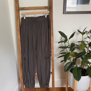 Olive green satin-like track pants for dressy look